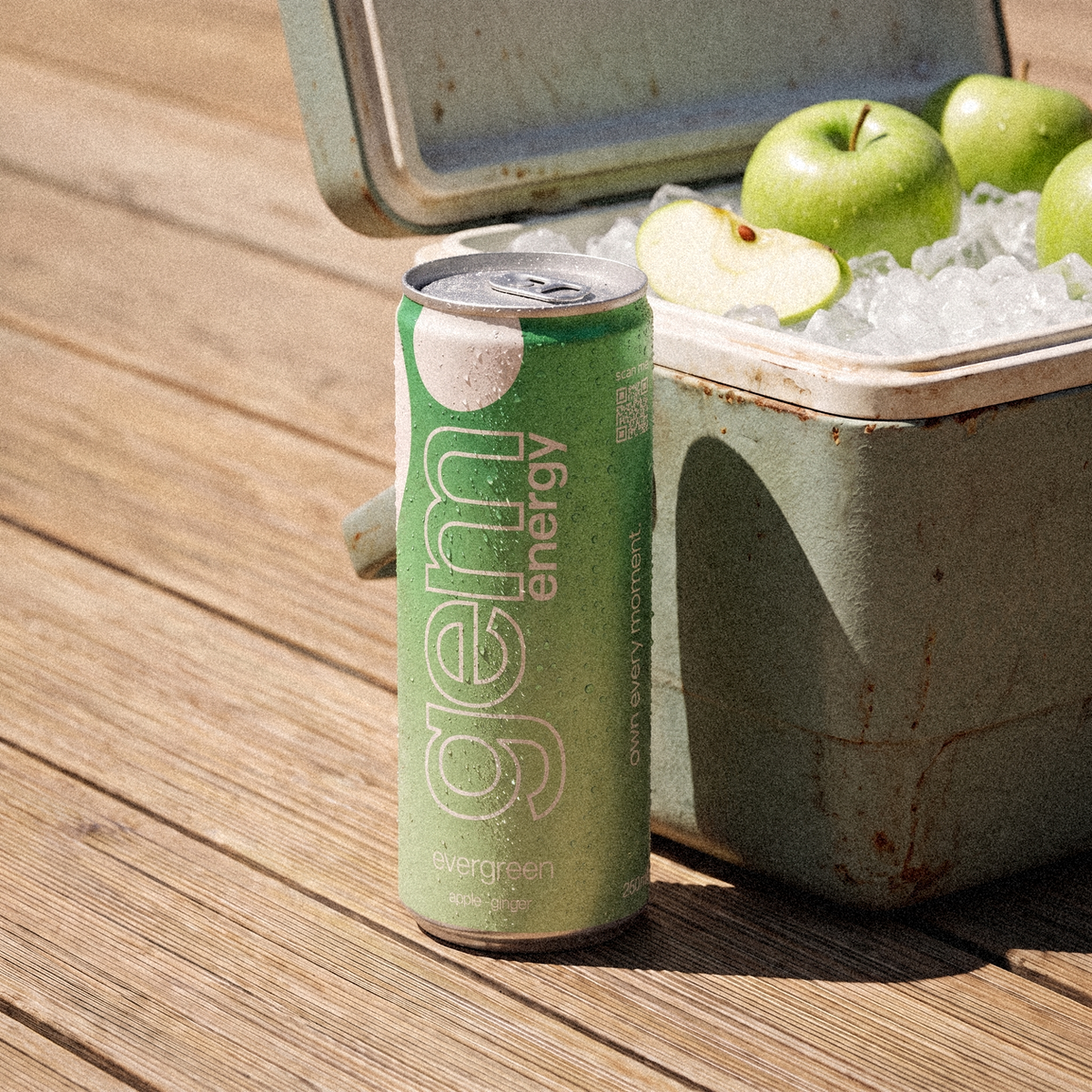 Gem Energy Evergreen can on a sunny wooden deck next to a cooler with ice and green apples