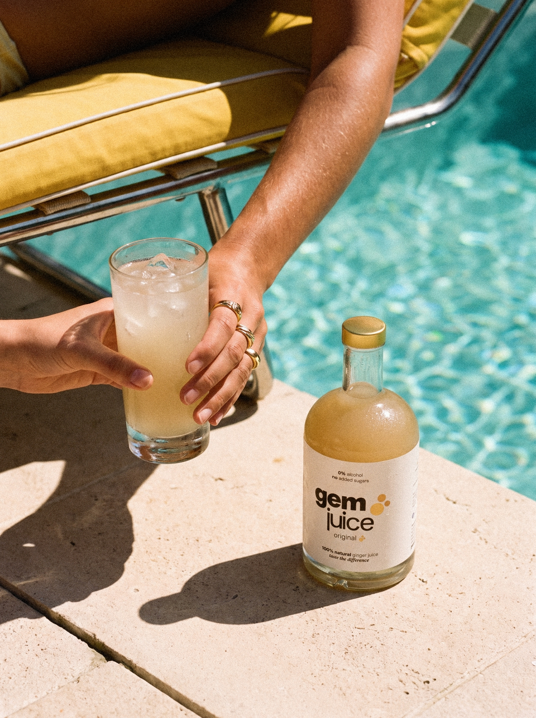 Gem Juice Original passed poolside, the ginger drink that does it all